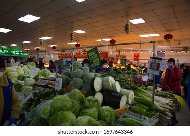 Beijing, China- April, 05, 2020: Chinese People Wear Protective Masks Shopping For Food In A Wet Market, Beijing Is Reopening And Backing To Normal Life