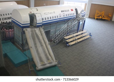 BEIJING, CHINA – APRIL 14 2015: Unidentified Air China Cabin Crew Members Prepare To Train For An Aircraft Evacuation On Land Using Emergency Slides At The Airline's Training Facility In Beijing.