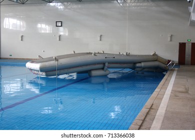 BEIJING, CHINA – APRIL 14 2015: An Aircraft Emergency Evacuation Slide And Raft Is Inflated And Readied For Use During Training Exercises At Air China's Cabin Crew Training Facility In Beijing.