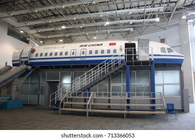 BEIJING, CHINA – APRIL 14 2015: An Air China Emergency Evacuation Drill Begins At Its Cabin Crew Training Centre Using A Specially-built Training Aircraft With Emergency Slide Deployed And Doors Open.