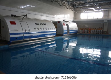 BEIJING, CHINA – APRIL 14 2015: Unidentified Air China Cabin Crew Members Prepare To Train For An Aircraft Ditching Evacuation In Water At The Airline's Training Facility In Beijing.