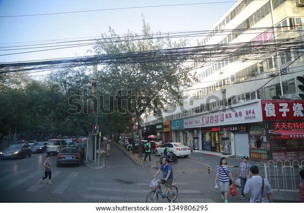 BEIJING, CHINA - AUGUST\
16, 2015: Busy street in Capital city of China filled with people\
and vehicles 
