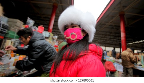 BEIJING, CHINA - CIRCA JANUARY 2013: Unidentified Woman With Mask On Antiques Market, 