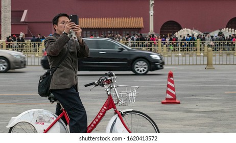 Beijing, China - Circa October 2016: A Local Cyclist Takes A Photo Of Tiananmen Square During Chinese Golden Week