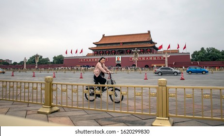 Beijing, China - Circa October 2017: A Local Women Bikes On At Tiananmen Square During The Chinese Golden Week