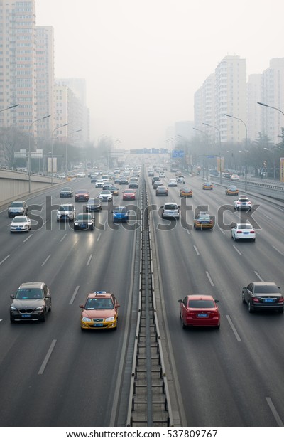 BEIJING,\
CHINA - DECEMBER 17, 2016: Streets in Beijing during air pollution.\
Pollution is a serious problem in Beijing. Cities in China face\
serious air pollution and poor air\
quality.