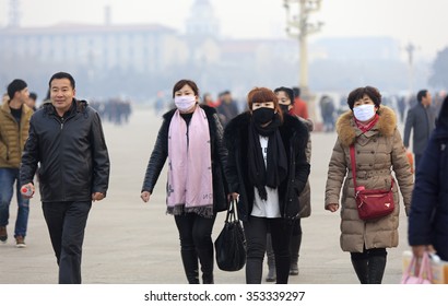 BEIJING, CHINA - DECEMBER 20, 2015: Unidentified People Wear Face Mask At Tiananmen Square. Beijing Issued A Red Alert For Air Pollution On Friday, Its Second Red Alert This Month. 

