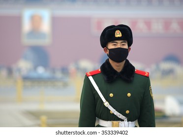 BEIJING, CHINA - DECEMBER 20, 2015: A Chinese Military Man Wears A Face Mask At Tiananmen Square. Beijing Issued A Red Alert For Air Pollution On Friday, Its Second Red Alert This Month. 