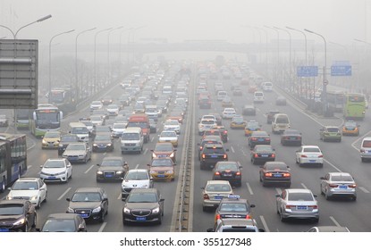 BEIJING, CHINA - DECEMBER 25, 2015: Traffic is seen at Guomao area in heavy smog. Today more than 200 flights were cancelled at the Beijing International Airport as heavy smog shrouded the city.