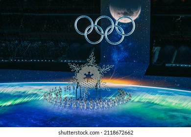 BEIJING, CHINA - FEBRUARY 04: A  view inside the stadium as the large snowflake and Olympic ring logo is seen while performer’s dance during the Opening Ceremony of the Beijing 2022 Winter Olympics
