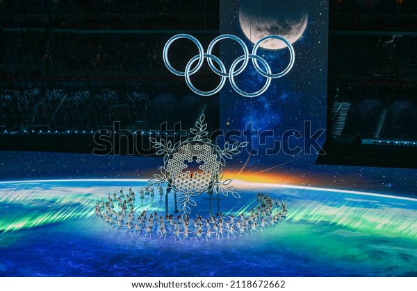 BEIJING, CHINA - FEBRUARY 04: A  view inside the\
stadium as the large snowflake and Olympic ring logo is seen while\
performer’s dance during the Opening Ceremony of the Beijing 2022\
Winter Olympics