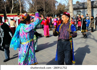 BEIJING, CHINA - FEBRUARY 2 - Old Chinese people originary from the muslim province of Xinjiang dance at a park near the Temple of Heaven, on February 2, 2014.