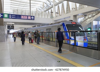 BEIJING, CHINA - FEBRUARY 4, 2016: Passengers are seen at a subway station waiting platform as train arrives. Beijing's 18 subway lines carry over 10 million passengers on an average weekday. 