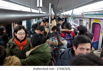BEIJING, CHINA - JAN. 12, 2014: Crowded subway train. Any subway trip, costs only 2 yuan (33 US cents); Beijing government's  plans to reform the current low-cost subway ticket system