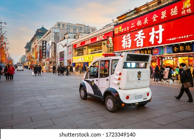 Beijing, China - Jan 9 2020: A small EV police  patrol car observes and guards people along the shopping street of Wangfujing