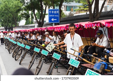 Beijing / China - June 21 2019: Pedicab (or cycle rickshaw) drivers waiting for passengers to take a ride in Beijing, China