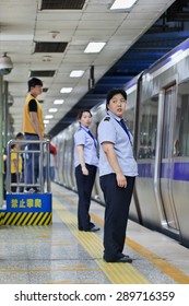 BEIJING, CHINA -JUNE 9, 2015. Personnel in subway station. Subway rail network serves Beijing urban and suburban districts with 18 lines, 319 stations, 527 KM track, averaging 9.2786 million trips per day. 
