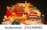 Beijing, china. large lantern composition at zigong festival. national color. traditional red chinese gate paifang, pailou. dragon and fenghuang are mythological birds. symboliz...