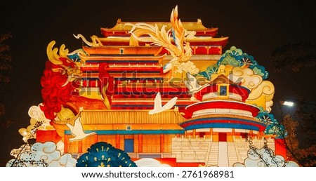 Beijing, china. large lantern composition at zigong festival. national color. traditional red chinese gate paifang, pailou. dragon and fenghuang are mythological birds. symboliz...
