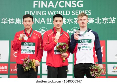 Beijing, China - MARCH 8, 2019: Golden Medallist Cao Yuan  Of China,Silver Medallist Xie Siyi, And Bronze Medallist Jack Laugher On Medals Podium Of Men’s 3m Springboard Final.