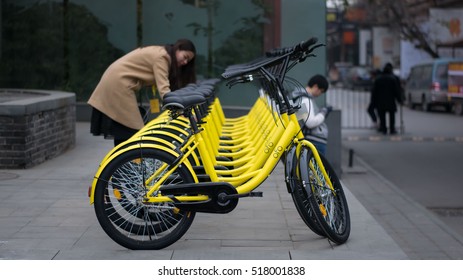 BEIJING, CHINA - NOVEMBER 18, 2016: Rows Of Bicycles Are Placed On The Side Of The Road In Beijing. Ofo Bikes Is The New Bike Sharing Company In China.