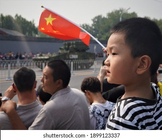 Beijing, China - October 1, 2018: Chinese Child With Flag Watching A Military Parade In The Capitol Beijing Celebrating The October 1 Anniversary Of Founding The People's Republic Of China In 1949