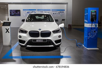 BEIJING, CHINA - OCTOBER 15, 2016: BMW X1 Electric Vehicle Is Connected To A Electric Charging Station At The China International New Energy Automobile Exhibition At China National Convention Center