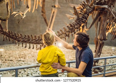 Beijing China, October 16, 2018: Dad And Boy Watching Dinosaur Skeleton In Museum