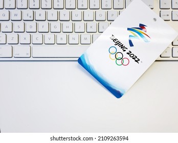 Beijing, China, October 2021: Blank white badge with the Beijing 2022 winter olympic games logo artwork on a computer keyboard. International event.