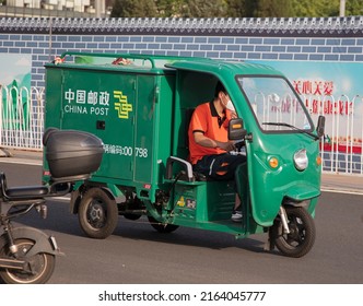 BEIJING, CHINA-JUNE 4, 2022: A China Post Driver Wearing A Face Mask Is Seen In Downtown; Beijing Has Eased COVID Restrictions As Outbreaks Fade.  