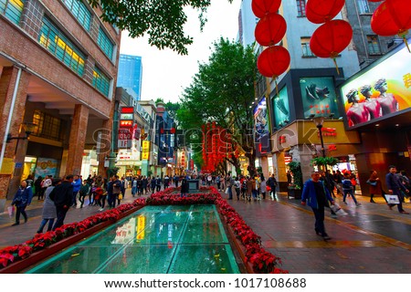 BEIJING LU, GUANGZHOU SHI, GUANGDONG, CHINA - JAN 2018: Busy Beijing Road street scene with a canopy of red lanterns and people shopping - Beijing Lu main shopping street, Guangzhou, China.