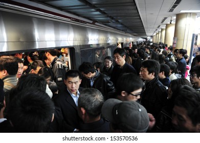 BEIJING - MARCH 15 2009:Crowd of Chines people during rush hour in Beijing subway. During  2019–20 coronavirus outbreak the Chines government closed tourist attractions to prevent mass gatherings.