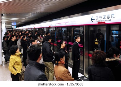 BEIJING - MARCH 18 2009:Large crowd of passengers on platform waits to Beijing subway.During  2019–20 coronavirus outbreak the Chines government closed tourist attractions to prevent mass gatherings.
