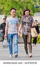 BEIJING-APRIL 28, 2016. Fashionable Couple In City Center. China's Economy, Boosted By Middle Class Wealth, Undergoes A Great Shift In Consumption, Driven By New Generation Of Prosperous Consumers.