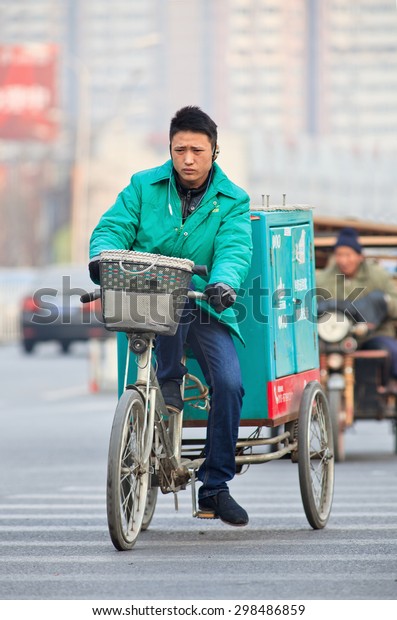 BEIJING-DEC. 4, 2012. Courier delivery service\
bike. Thanks to the country\'s e-commerce boom, China has currently\
more than 35,000 courier delivery services that makes speedy home\
delivery possible.
