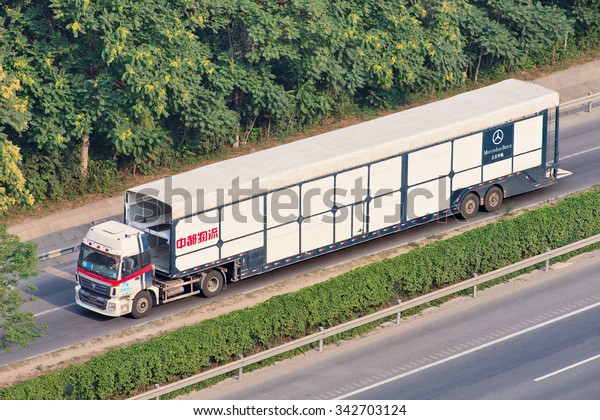 BEIJING-JULY 7, 2015. Over sized Mercedes Benz car\
carrier. These illegal car trailers have lengths up to 40m. They\
are prohibited enter urban areas and load trailers outside Beijing\
fifth ring road. 