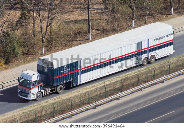 BEIJING-MARCH 25, 2016. Oversized Mercedes Benz car\
carrier. These illegal car trailers have lengths up to 40m. They\
are prohibited enter urban areas and load trailers outside Beijing\
fifth ring road.
