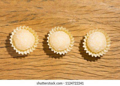 Beijinho Is A Handmade Candy From Brazil. Made With Condensed Milk And Coconut. Children Brithday Party Sweet. Overhead Of Candy Ball On Rustic Wood Table.