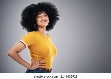 Being Confident Is A Bold Move. Studio Shot Of An Attractive Young Woman Posing Against A Grey Background.