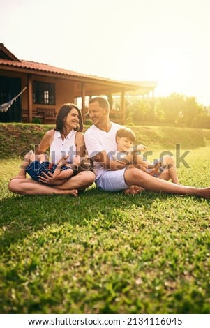 Being with family is bliss. Shot of a happy family bonding together outdoors.