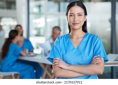 Being A Nurse Is Not Easy. Shot Of A Young Nurse In The Midst Of A Staff Meeting.