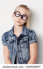 Being Quirky. Portrait Of A Young Girl Wearing Big Round Glasses Posing In The Studio.