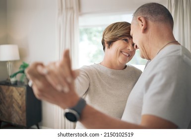 Being In Your Arms Is My Favourite Place. Shot Of A Mature Couple Slow Dancing In Their Lounge.