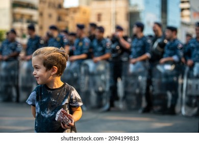 Beirut, Lebanon - October 25, 2019 - Child Standing In Front Of Police In A Demonstration