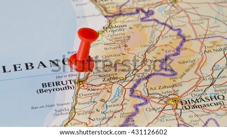 Beirut marked on map with red pushpin. Selective focus on the word Beirut and the pushpin. Pin is in an angle. Midground is sharp while foreground and background is blurry.