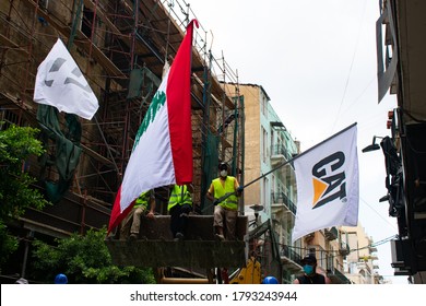 Beirut/Lebanon - 08/09/2020: Rescue Workers On A Backhoe Bucket Waving The National Flag During Disaster Relief Work In Downtown Beirut