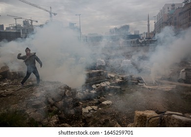 Beirut/Lebanon-02.11.20: Frontliner Protester Throws Back To Police Cannister With Tear Gas In The Archaeological Site Of Antique Roman Ruins During Anti-government Protest In Beirut.