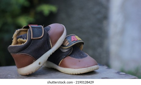 Bekasi City, Indonesia 15 August 2022 : A Pair Of Children's Shoes That Are Worn Out And No Longer Used