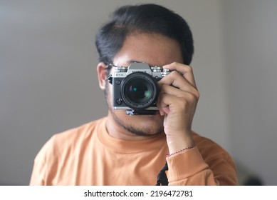 Bekasi, February 10, 2021: Selfie Of Young Asian Guy In Mirror, Camera Lens Closeup Is Covering The Face. Blurry And Selective Focus.