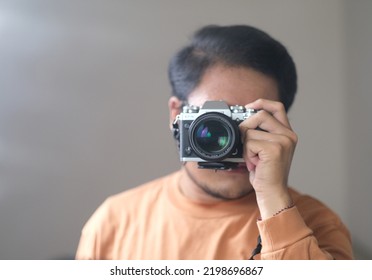 Bekasi, February 10, 2021: Selfie Of Young Asian Guy In Mirror, Camera Lens Closeup Is Covering The Face. Blurry And Selective Focus.